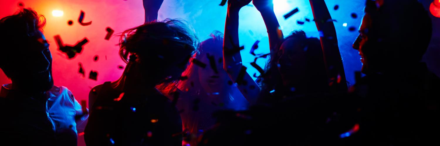 Silhouettes of people dancing in a nighclub under red and blue lights Silhouettes of people dancing in a nighclub under red and blue lights