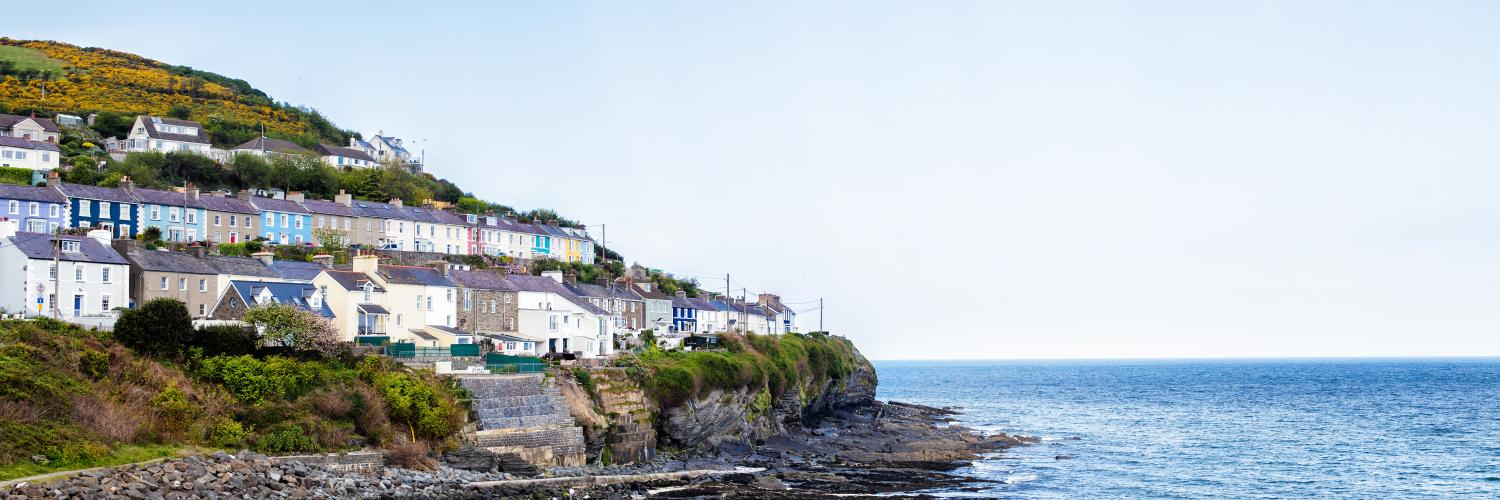 Coloured houses overlooking the ocean in New Quay, Wales Coloured houses overlooking the ocean in New Quay, Wales