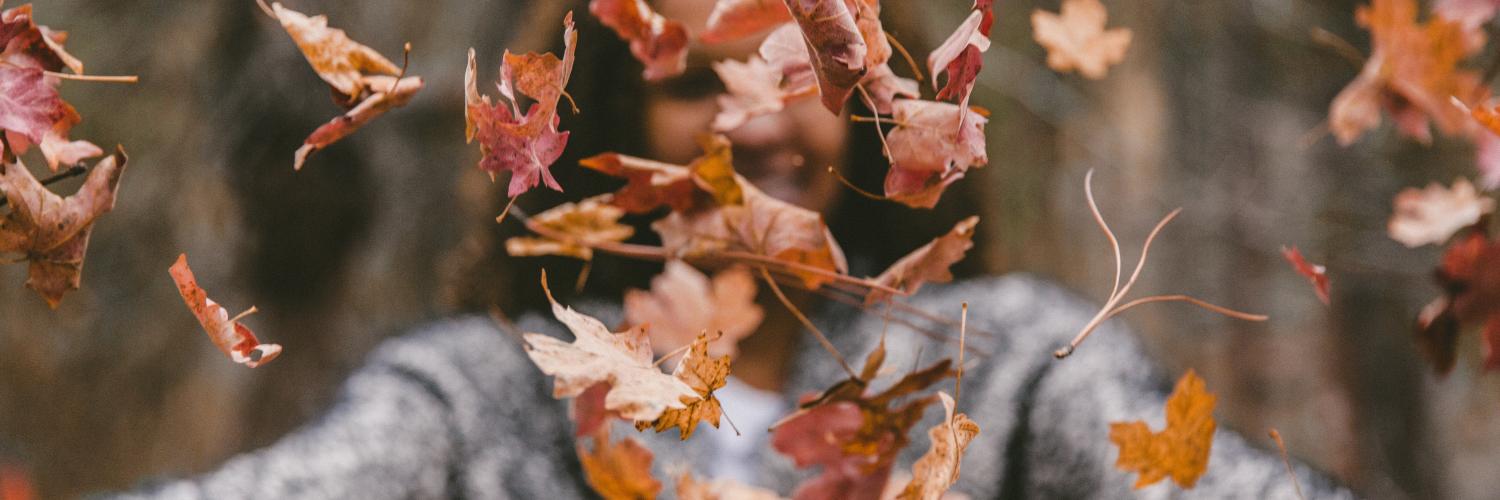 Woman throwing leaves Woman throwing leaves