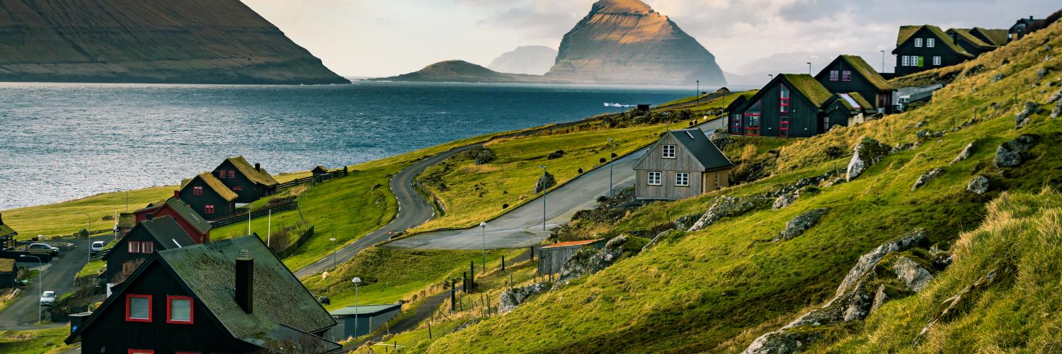 Kirkjubøur and Koltur at Foaroe Islands. Traditional black tarred timber and grass roofs.