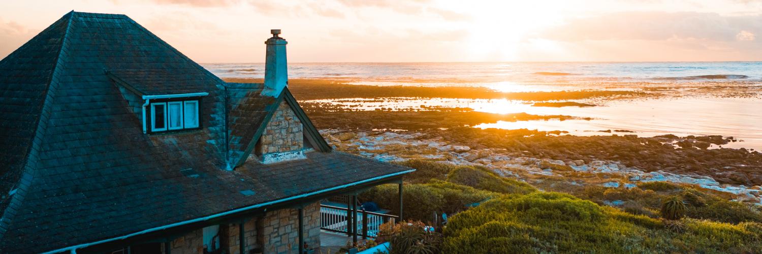 aerial photo of house near calm body of water