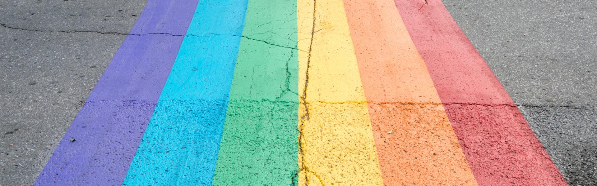 A rainbow flag painted onto the road A rainbow flag painted onto the road