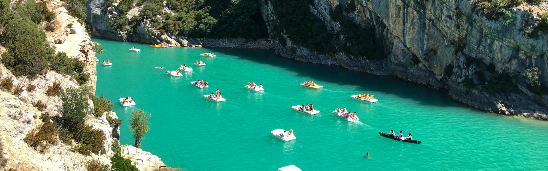 people swimming on lake during daytime