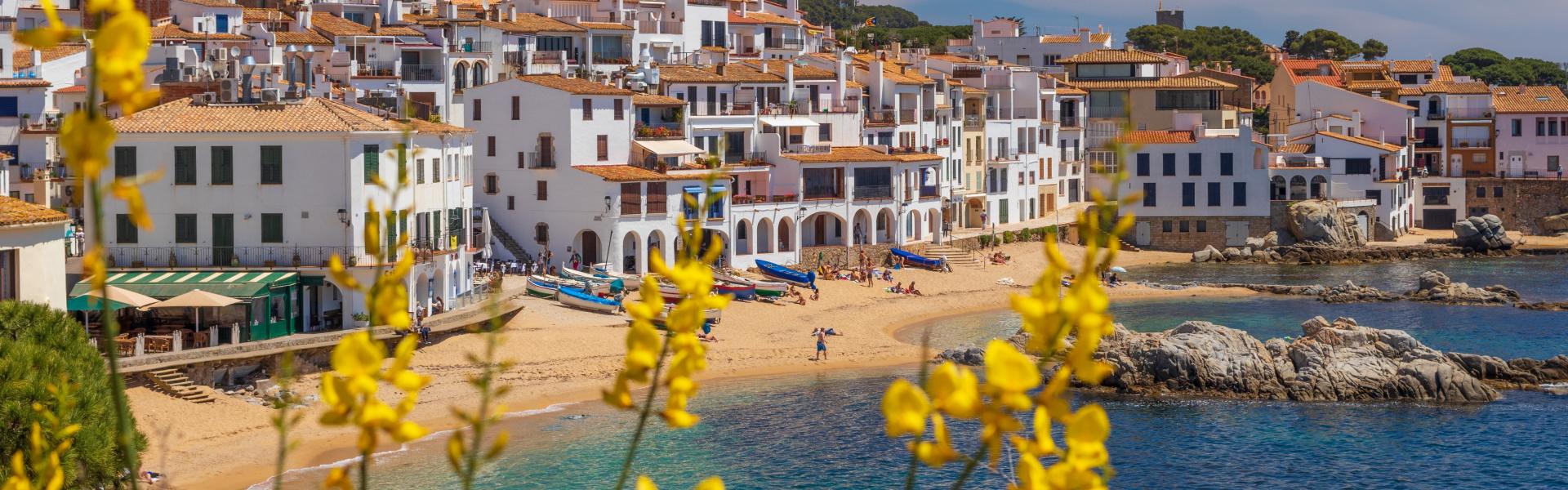 yellow and white houses near body of water during daytime
