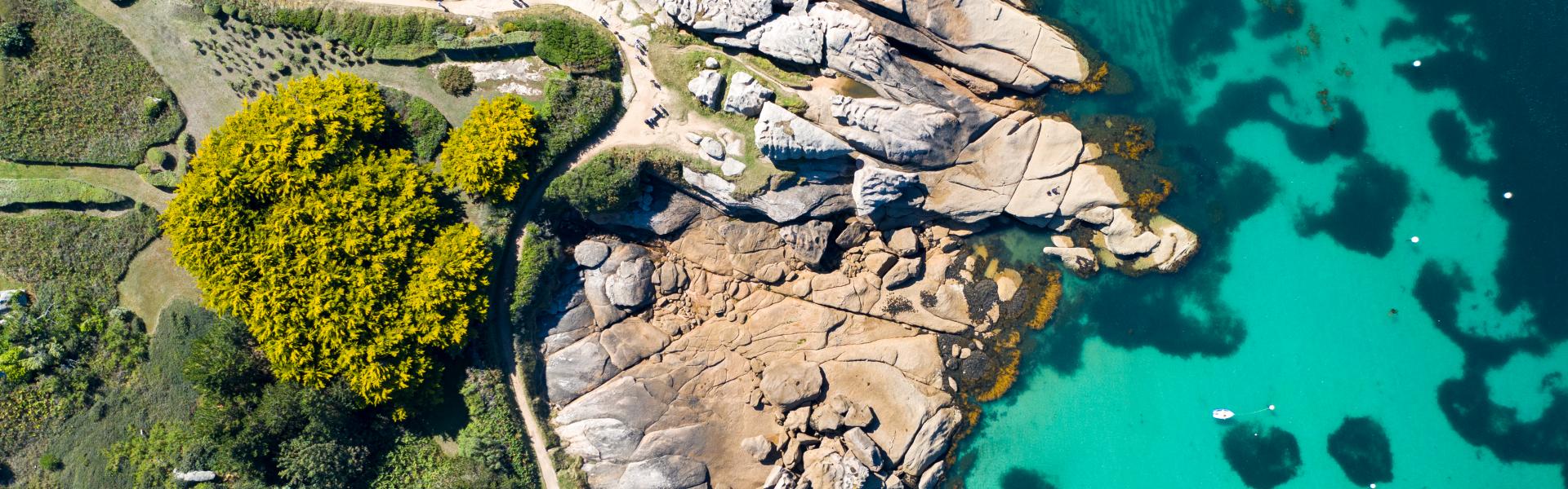 This photo was taken in Tregastel near Perros-Guirrec .This is the cote de Granit Rose with beautiful blue waters rocks and boats. This is an aerial photo.