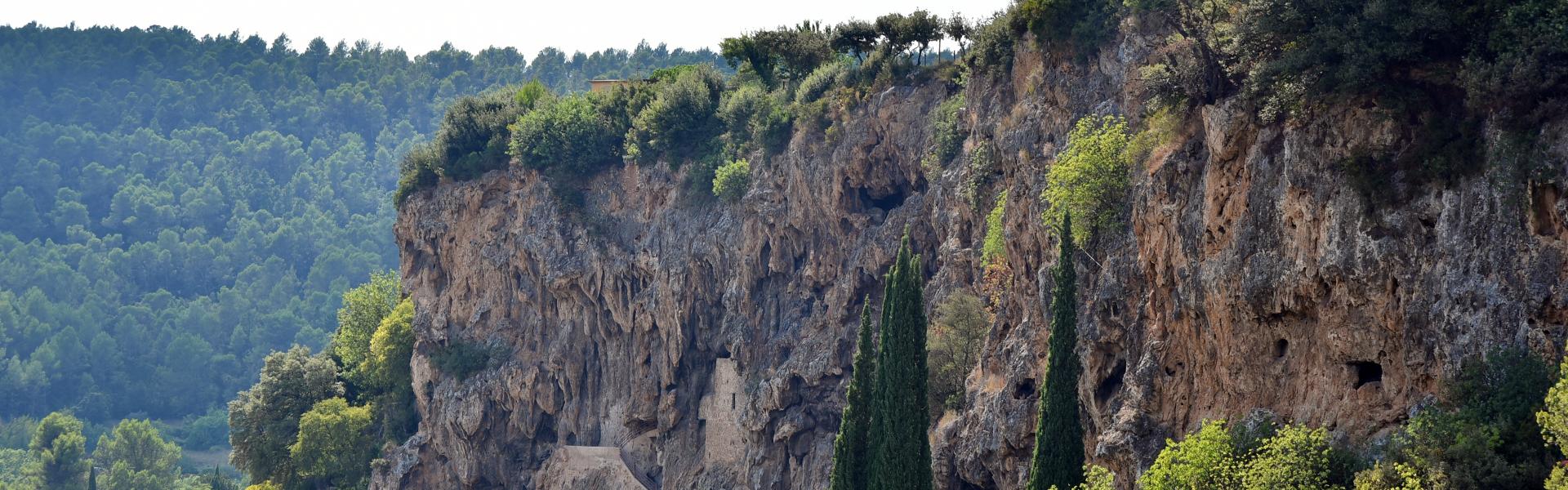 landscape of Cotignac city with troglodyte cavesand tower on top. Provence, France.