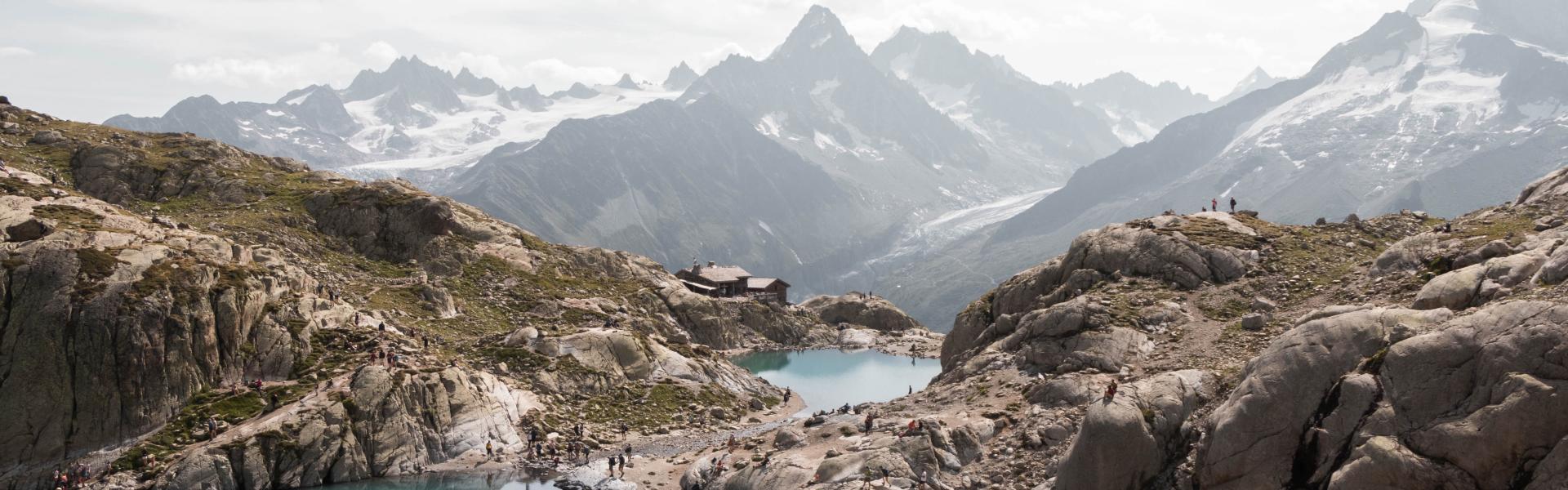 lake in the middle of mountains during daytime