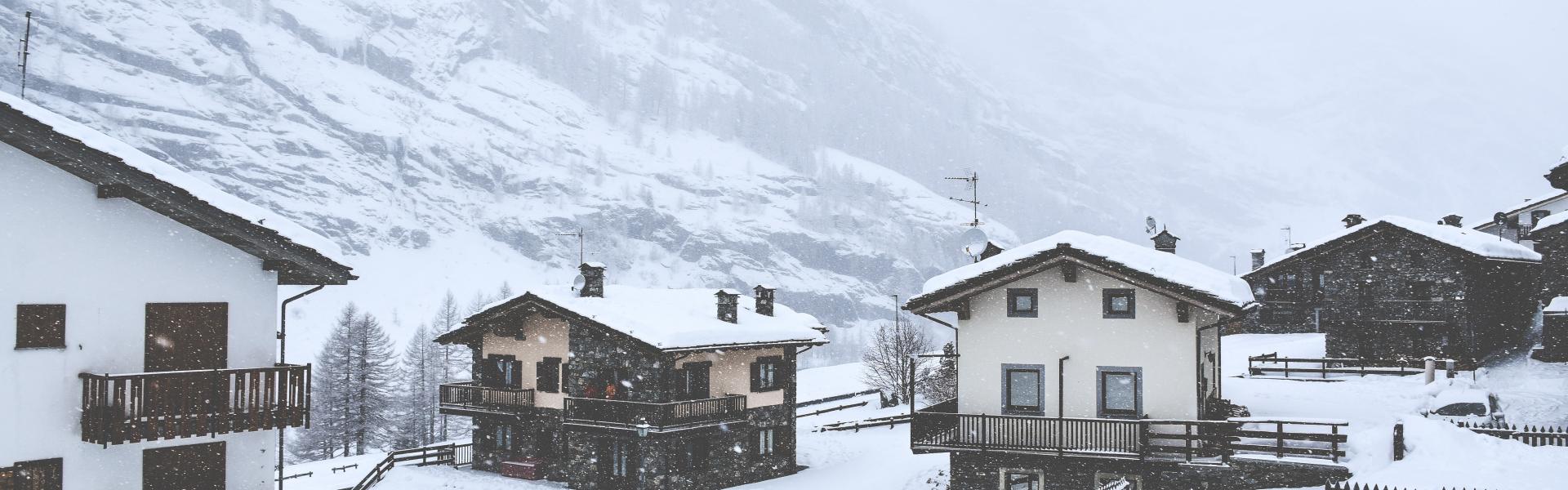 snow covered houses overlooking mountain