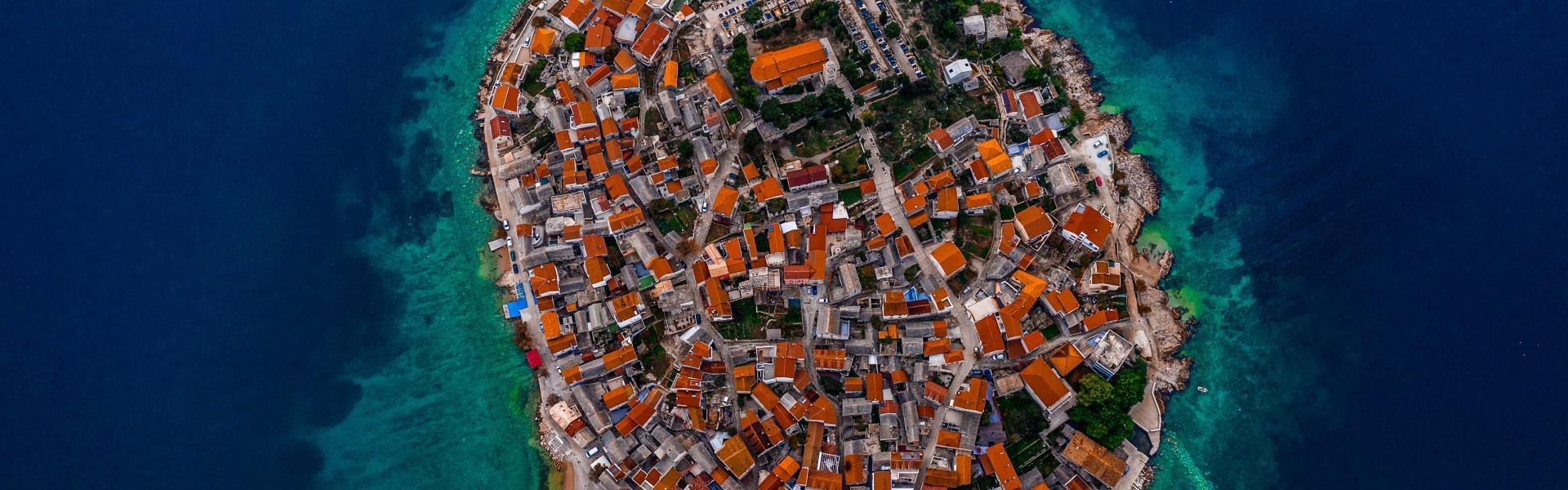 aerial photo of buildings and body of water