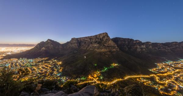 View of a mountain with the city of Cape Town below, lit up at night