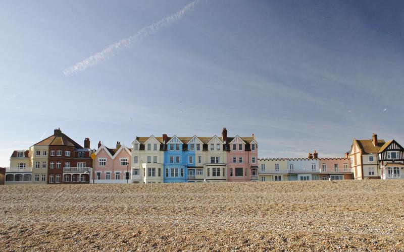 A row of colourful terraced houses next to a beach